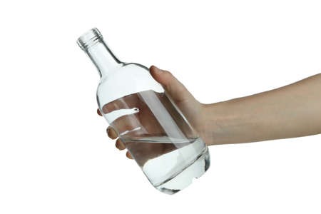 Female hand hold blank bottle of vodka, isolated on white backgroundの写真素材