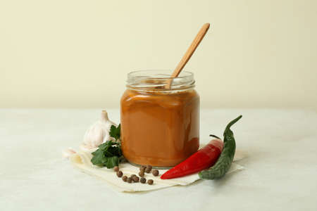 Jar with zucchini caviar on white textured tableの写真素材