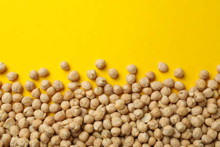 Fresh chickpea on yellow background, space for text