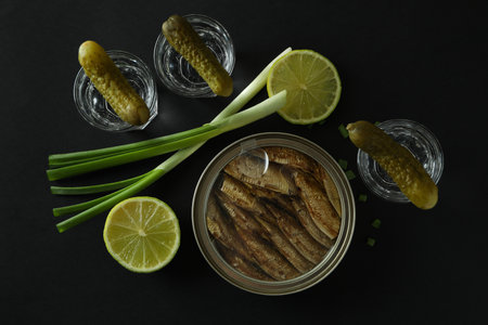 Shots of vodka and tasty snacks on black background, top viewの写真素材