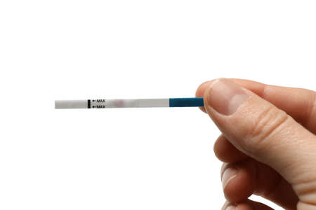Female hand hold pregnancy test strip, isolated on white background