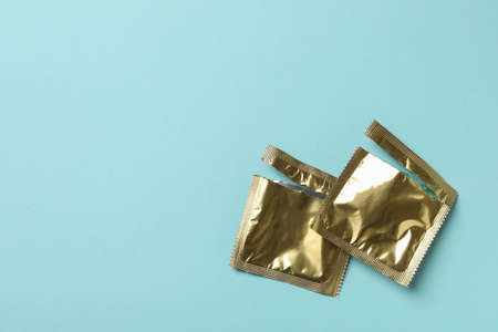 Empty blank condom packagings on blue backgroundの写真素材