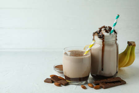 Concept of delicious food with chocolate milkshake and banana on white textured tableの写真素材