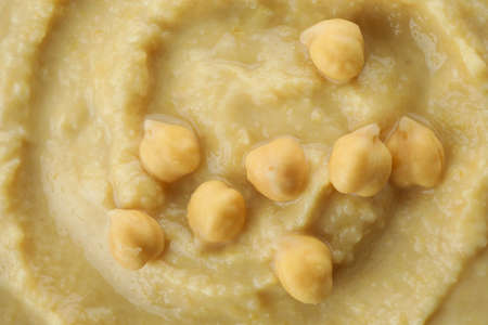 Fresh hummus on whole background, close up