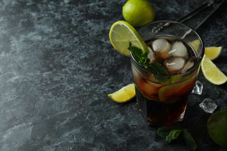 Glass of Cuba Libre and ingredients on black smokey backgroundの写真素材
