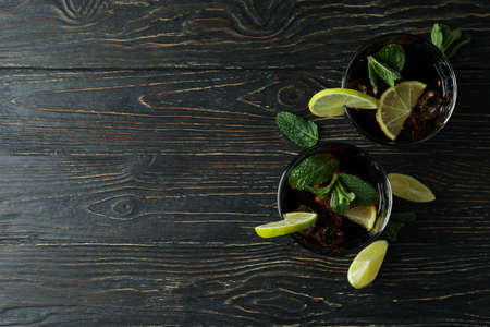 Glasses of Cuba Libre cocktail on wooden tableの写真素材