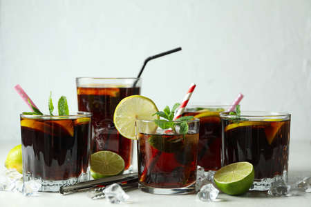 Glasses of Cuba Libre on white textured table