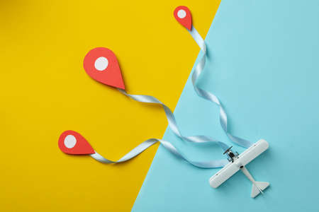 Travel concept with paper plane on two tone backgroundの写真素材