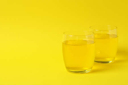 Glasses of lemon jelly on yellow backgroundの写真素材