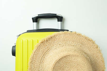 Straw hat and travel bag on white backgroundの写真素材