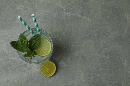 Glass of mojito cocktail on gray tableの写真素材