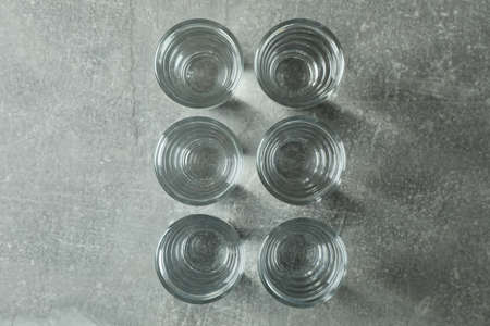 Shots with vodka on gray background, top viewの写真素材