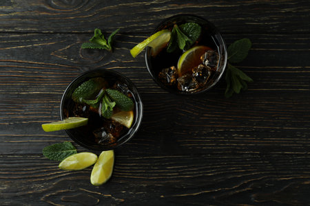 Glasses of Cuba Libre cocktail on wooden tableの写真素材