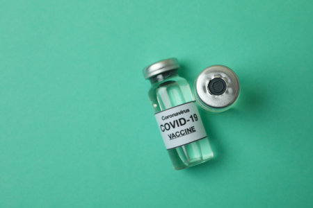 Vials of Covid - 19 vaccine on mint background