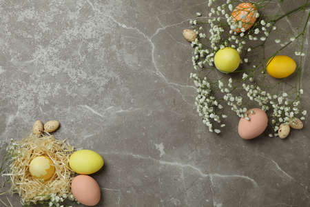 Easter eggs and gypsophila flowers on gray textured backgroundの写真素材