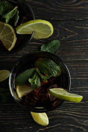 Glasses of Cuba Libre cocktail on wooden tableの写真素材