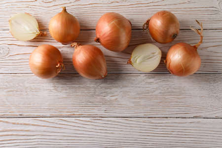 Ripe fresh onion on wooden background, space for textの写真素材