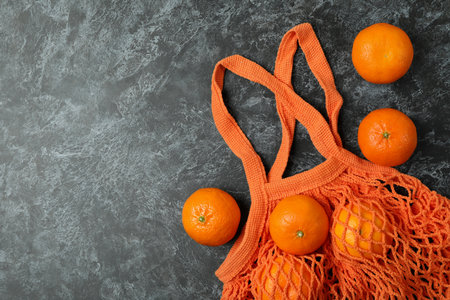 String bag with mandarins on black smokey backgroundの写真素材