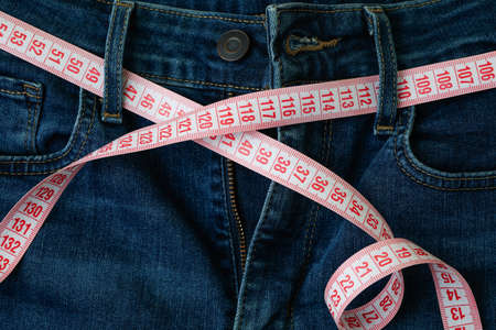 Jeans with measuring tape on whole backgroundの写真素材