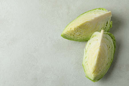 Fresh green cabbage on white textured tableの写真素材