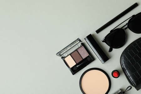 Cosmetic bag, makeup cosmetics and sunglasse on gray backgroundの写真素材