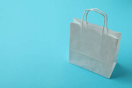 Blank paper bags on mint background, space for textの写真素材