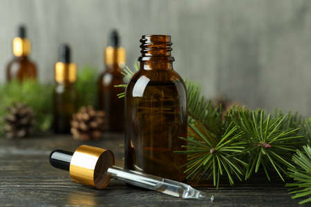 Aromatherapy concept with pine oil on wooden table