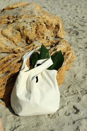 Eco bag with leaves outdoor on beachの写真素材