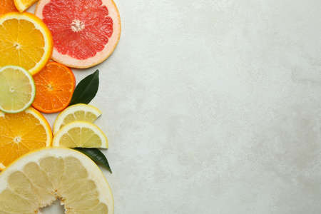 Ripe citrus slices on white textured backgroundの写真素材