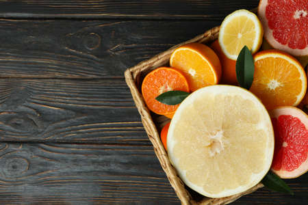 Basket with fresh citrus on wooden tableの写真素材