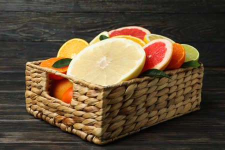 Basket with fresh citrus on wooden tableの写真素材