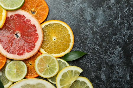 Ripe citrus slices on black smoky backgroundの写真素材