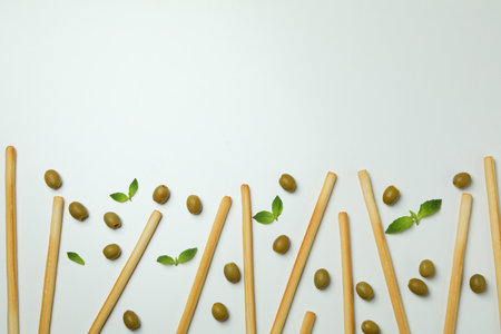 Grissini, olives and basil on white background, space for textの写真素材