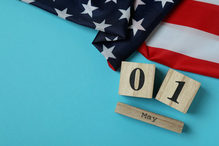 American flag and wood calendar with 1 may on blue background