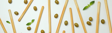 Grissini, olives and basil on white backgroundの写真素材