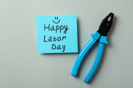 Text Happy Labor Day and pliers on gray backgroundの写真素材