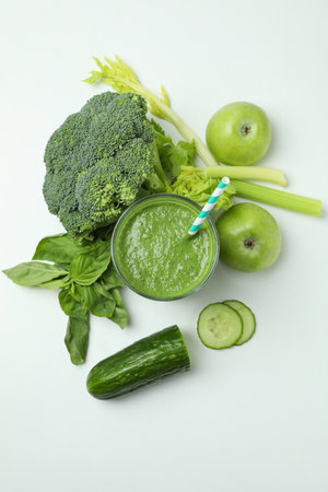 Glass of green smoothie and ingredients on white background, top viewの写真素材