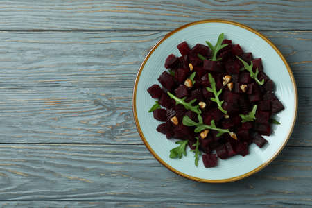 Bowl with fresh beet salad on wooden tableの写真素材
