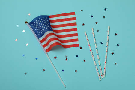 American flag, glitter and straws on blue backgroundの写真素材