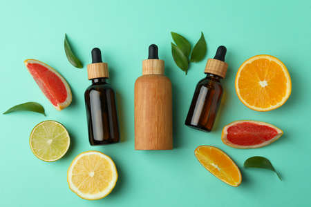 Dropper bottles with oil and citrus on mint backgroundの写真素材
