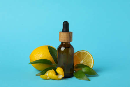 Dropper bottle with oil and lemons on blue backgroundの写真素材