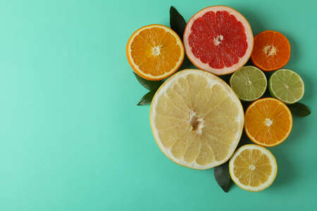 Ripe citrus on mint background, space for textの写真素材