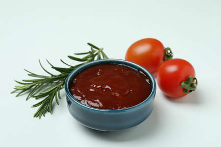 Barbecue sauce, rosemary and tomatoes on white backgroundの写真素材