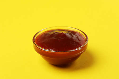 Bowl of barbecue sauce on yellow backgroundの写真素材