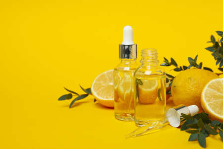 Concept of natural cosmetics with lemon oil on yellow backgroundの写真素材