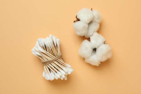 Cotton swabs and cotton on beige backgroundの写真素材