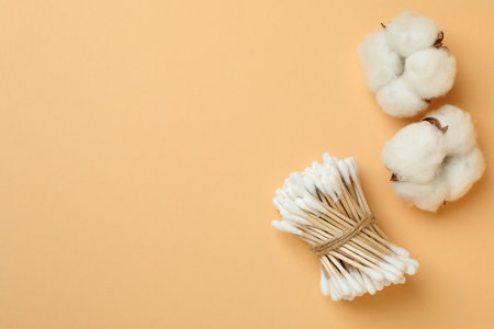 Cotton swabs and cotton on beige backgroundの写真素材