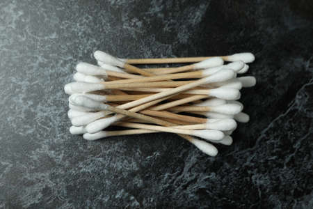 Cotton swabs on black smoky background, close up