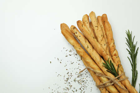 Grissini breadsticks with spices on white backgroundの写真素材