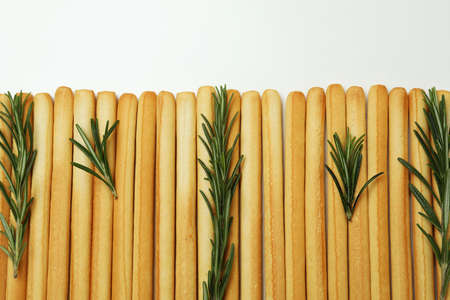 Grissini breadsticks with rosemary on white backgroundの写真素材